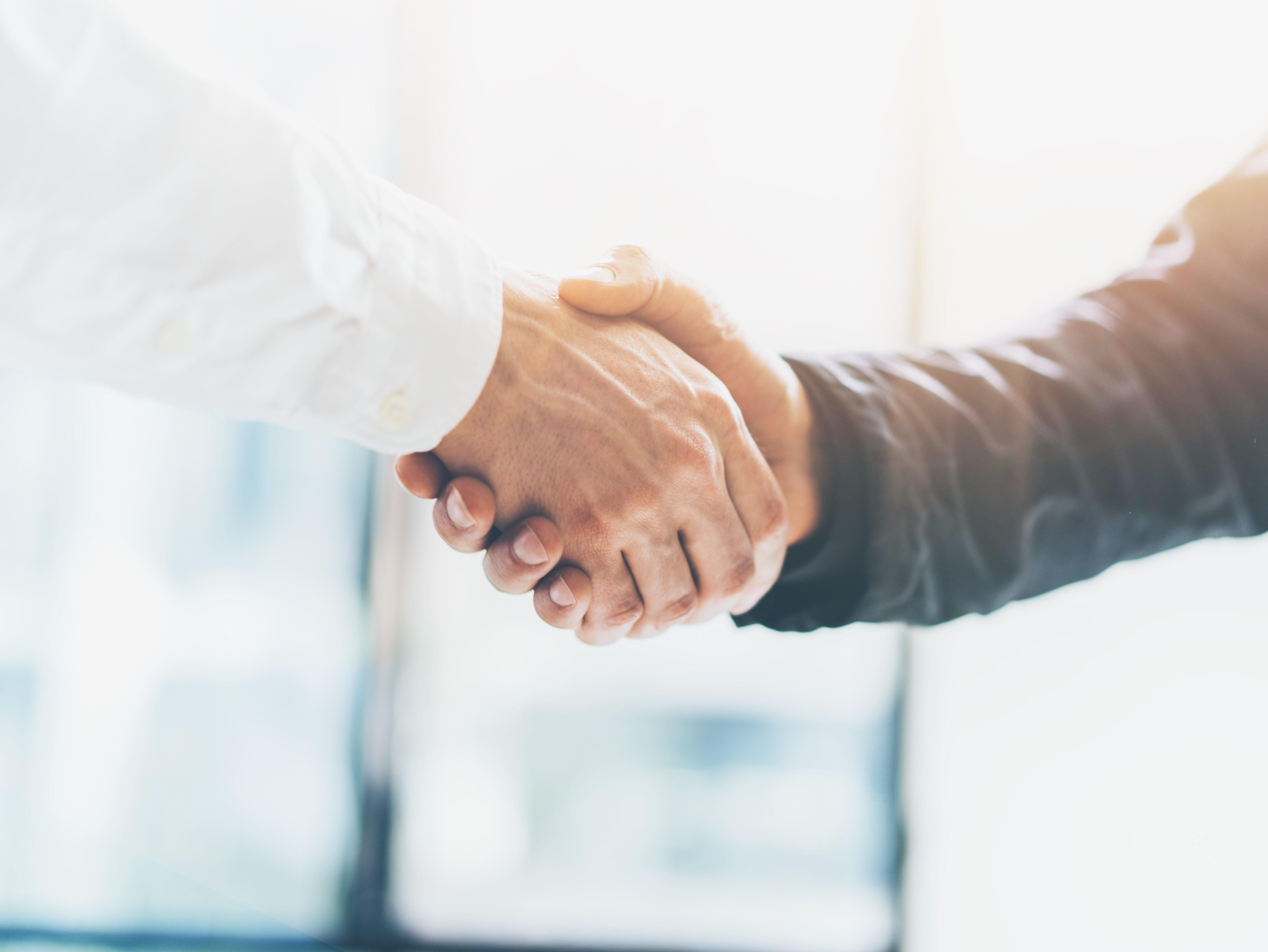Business partnership meeting. Picture businessmans handshake. Successful businessmen handshaking after good deal. Horizontal, blurred background
